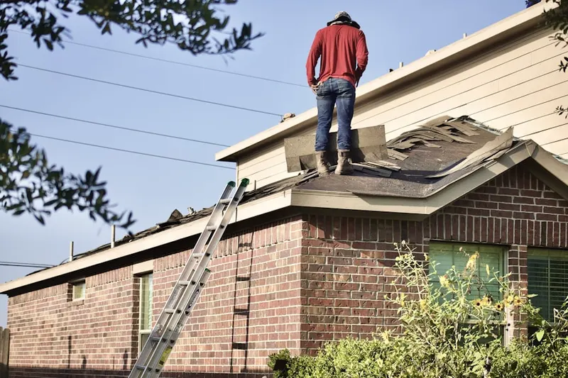 Professional roofer working on a residential roof in Hampton Beach
